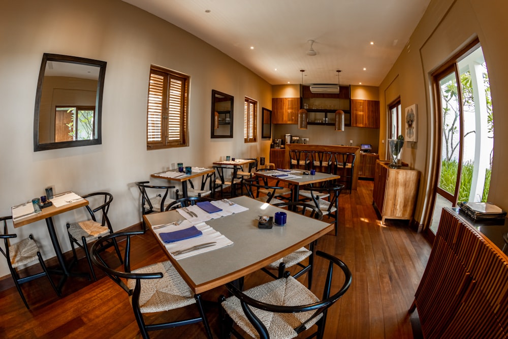 a restaurant with tables and chairs and a large window