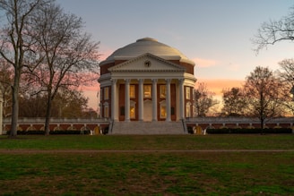 a building with a dome in the middle of a field