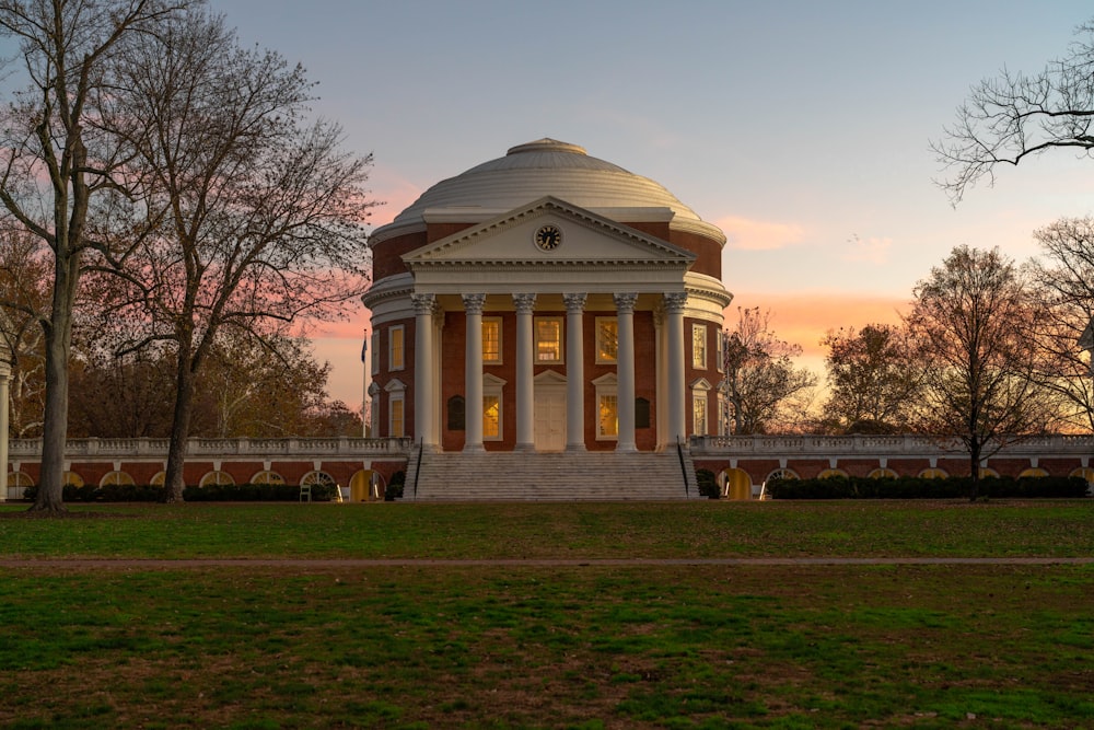 a building with a dome in the middle of a field