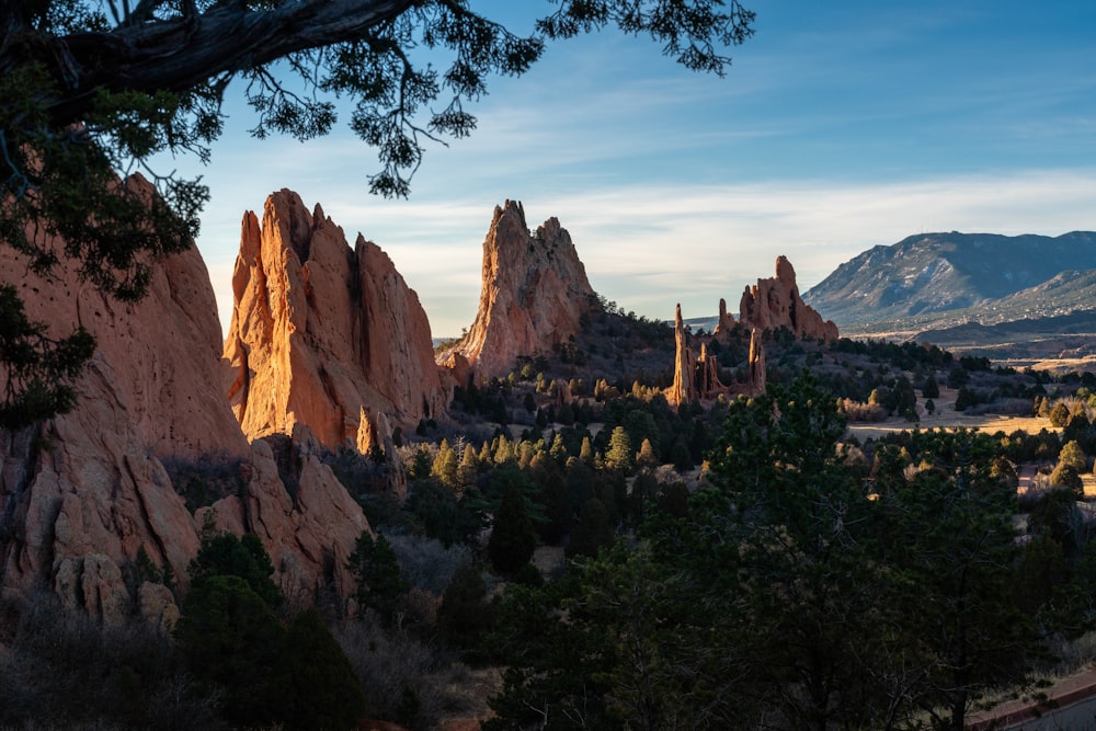 a scenic view of a mountain range with trees and mountains in the background