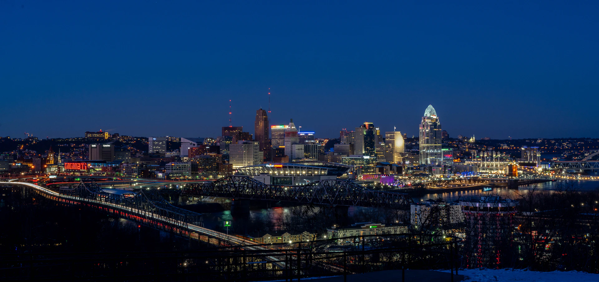 a view of a city at night from a hill