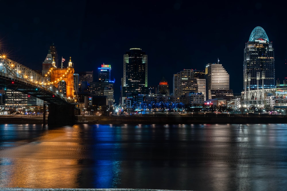 a night view of a city with a bridge over the water