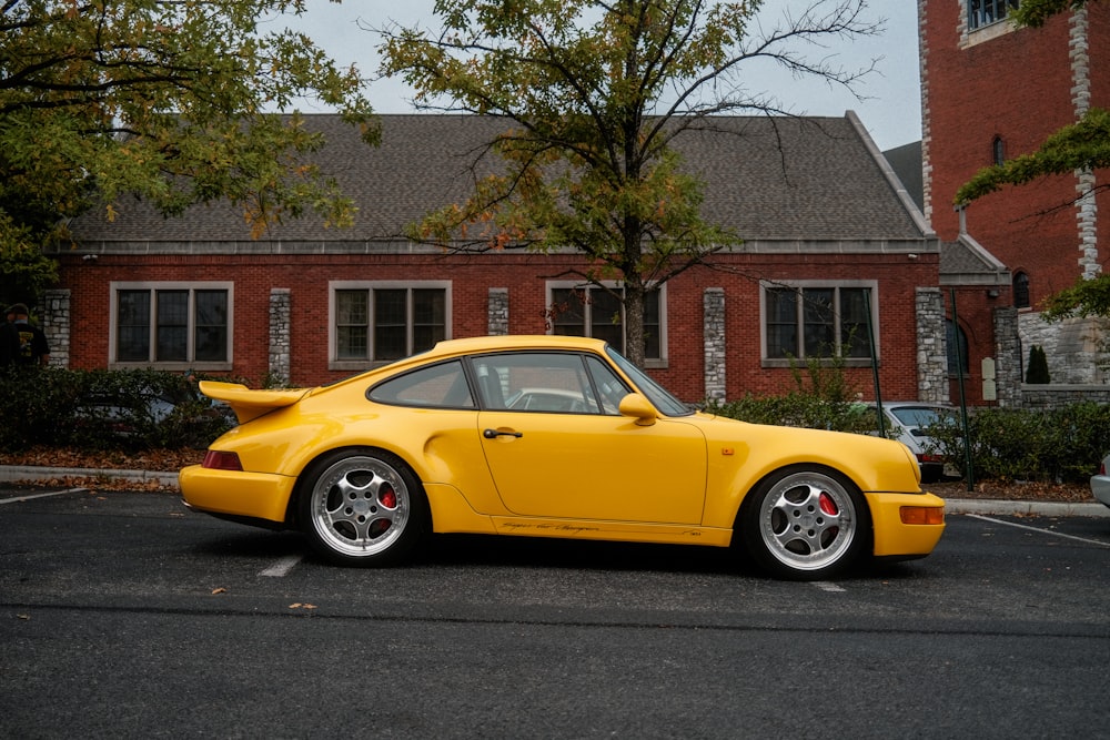 a yellow sports car parked in a parking lot