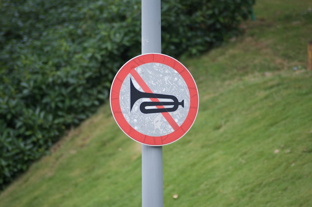 a red and white sign that is on a pole