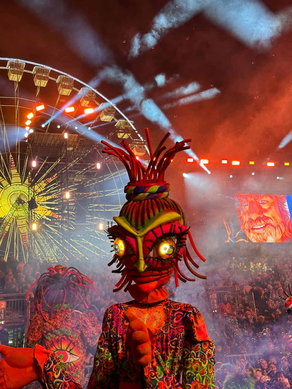 a person in a costume standing in front of fireworks