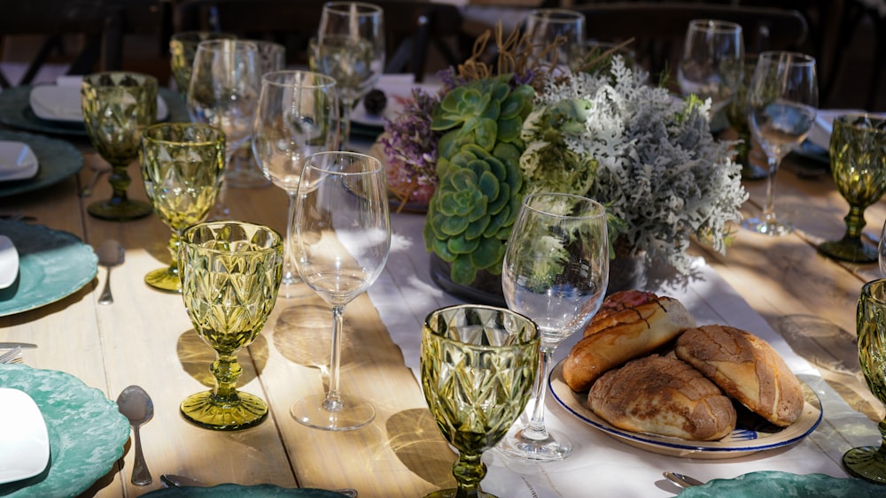 a table with a plate of food and glasses on it