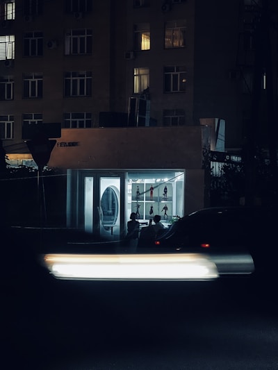 a car passing by a building at night