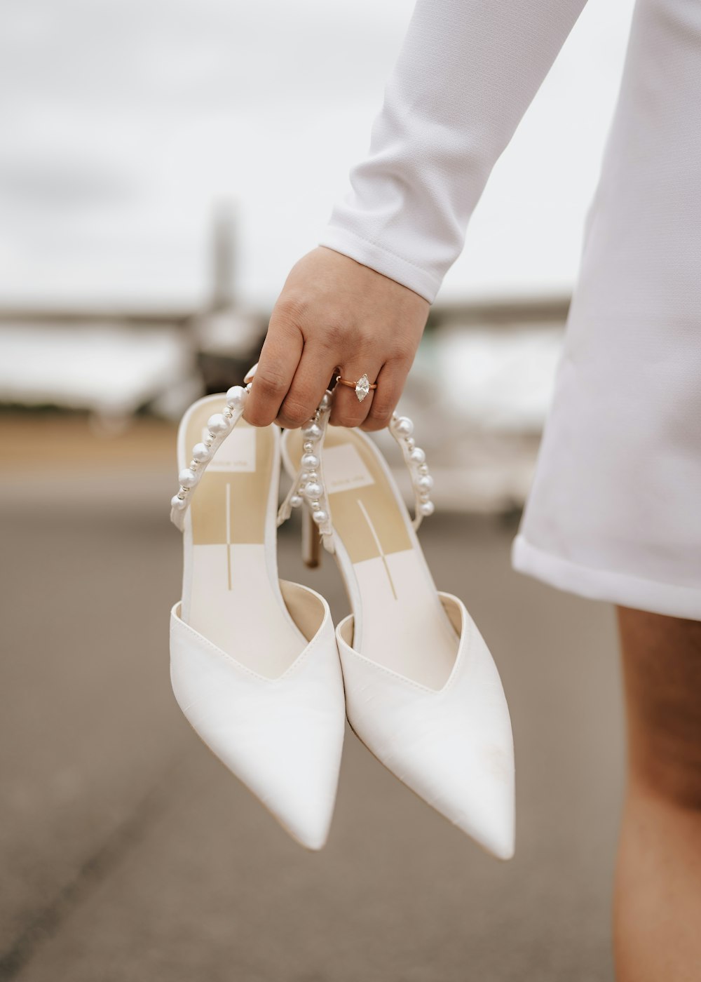 a close up of a person holding a pair of shoes