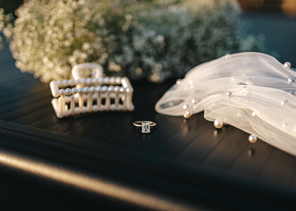 a close up of a ring and a veil on a table