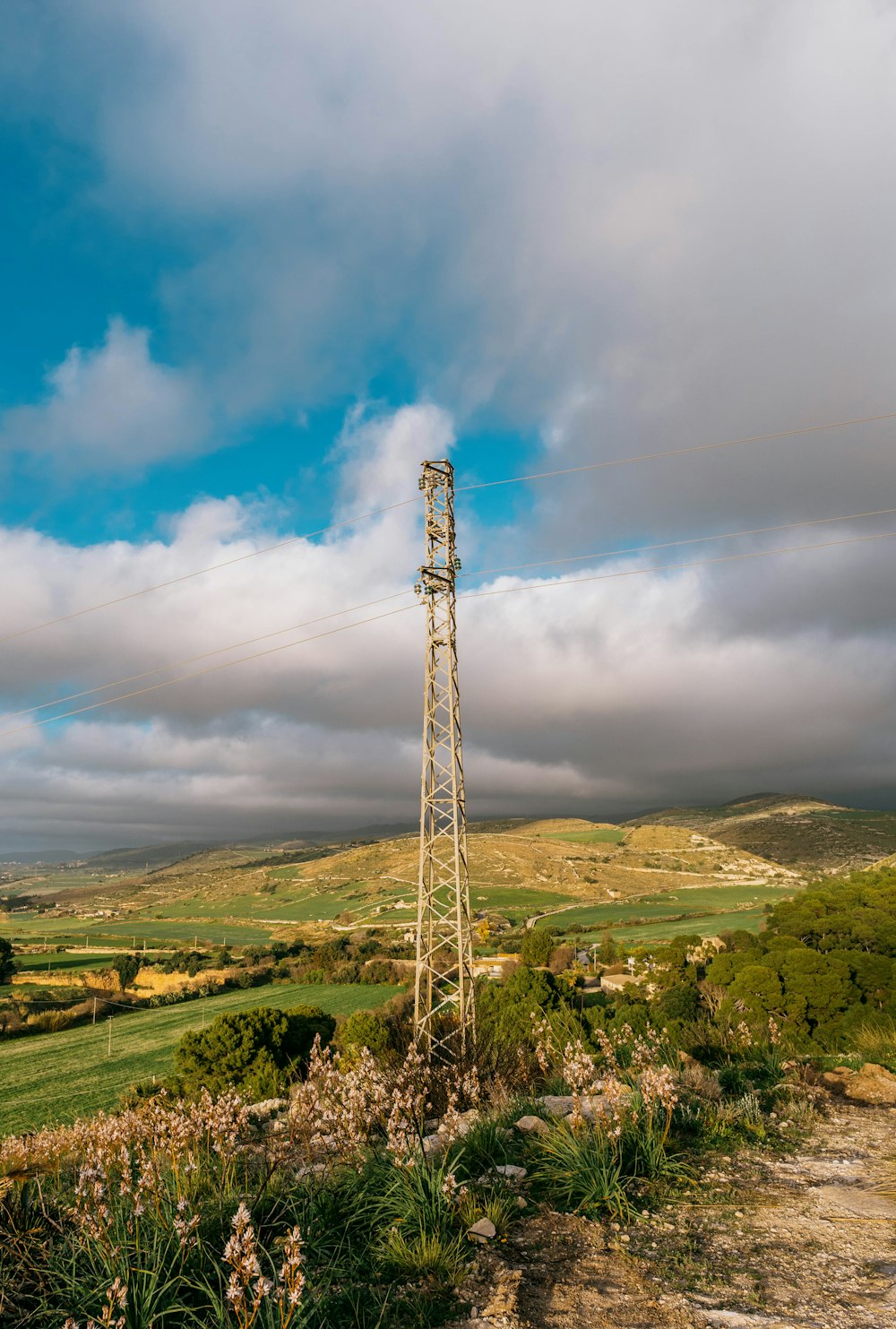 a tall tower sitting on top of a lush green hillside