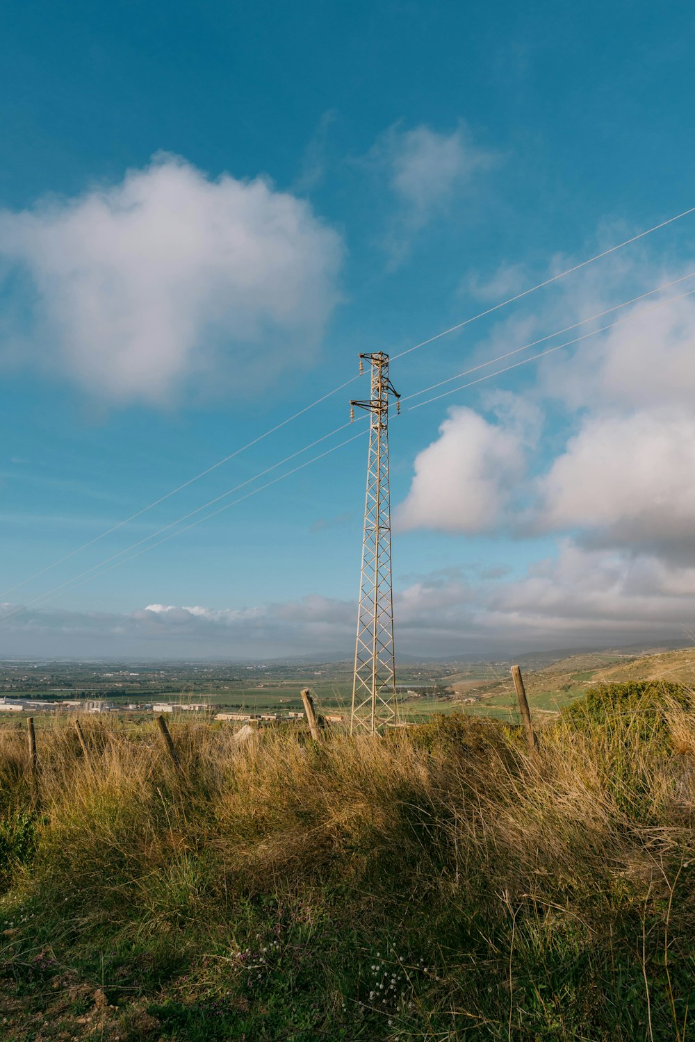 a tall tower sitting on top of a lush green hillside