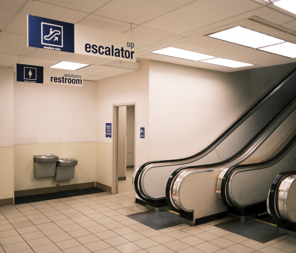 a row of escalators in a public restroom
