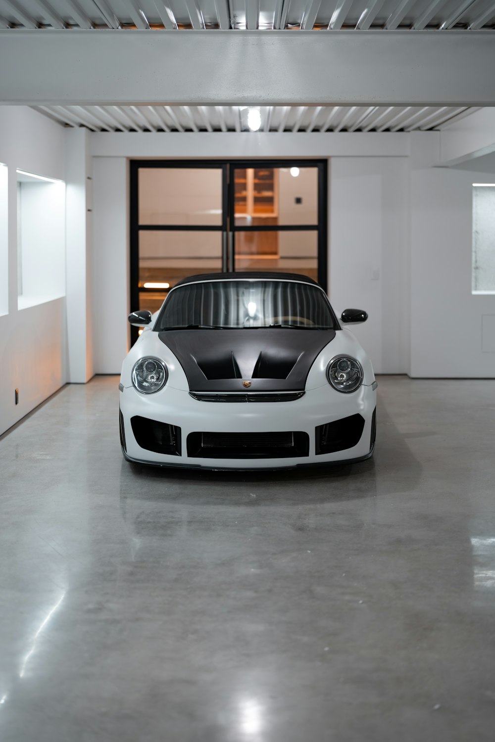 a white sports car parked in a garage