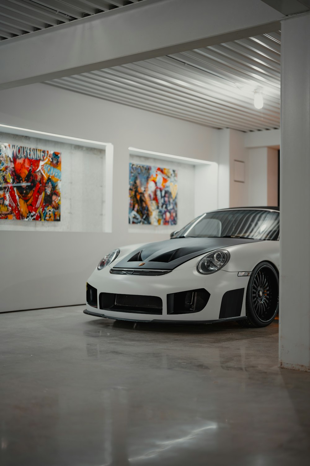 a white sports car parked in a garage