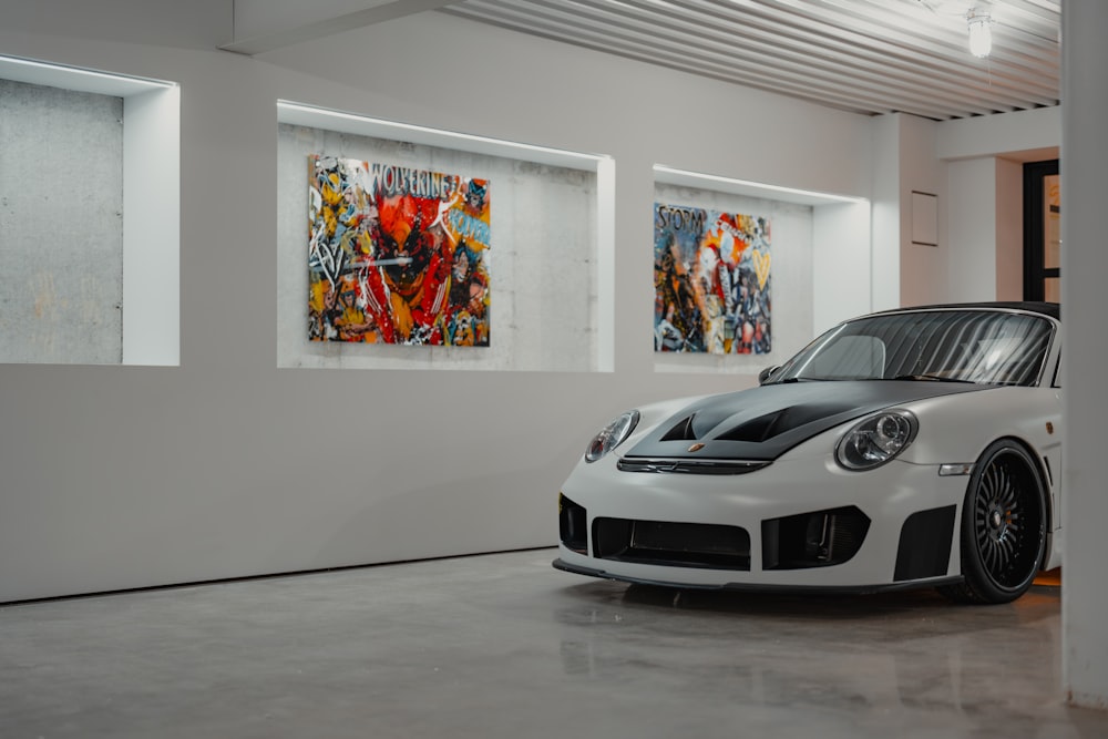 a white sports car parked in a white room