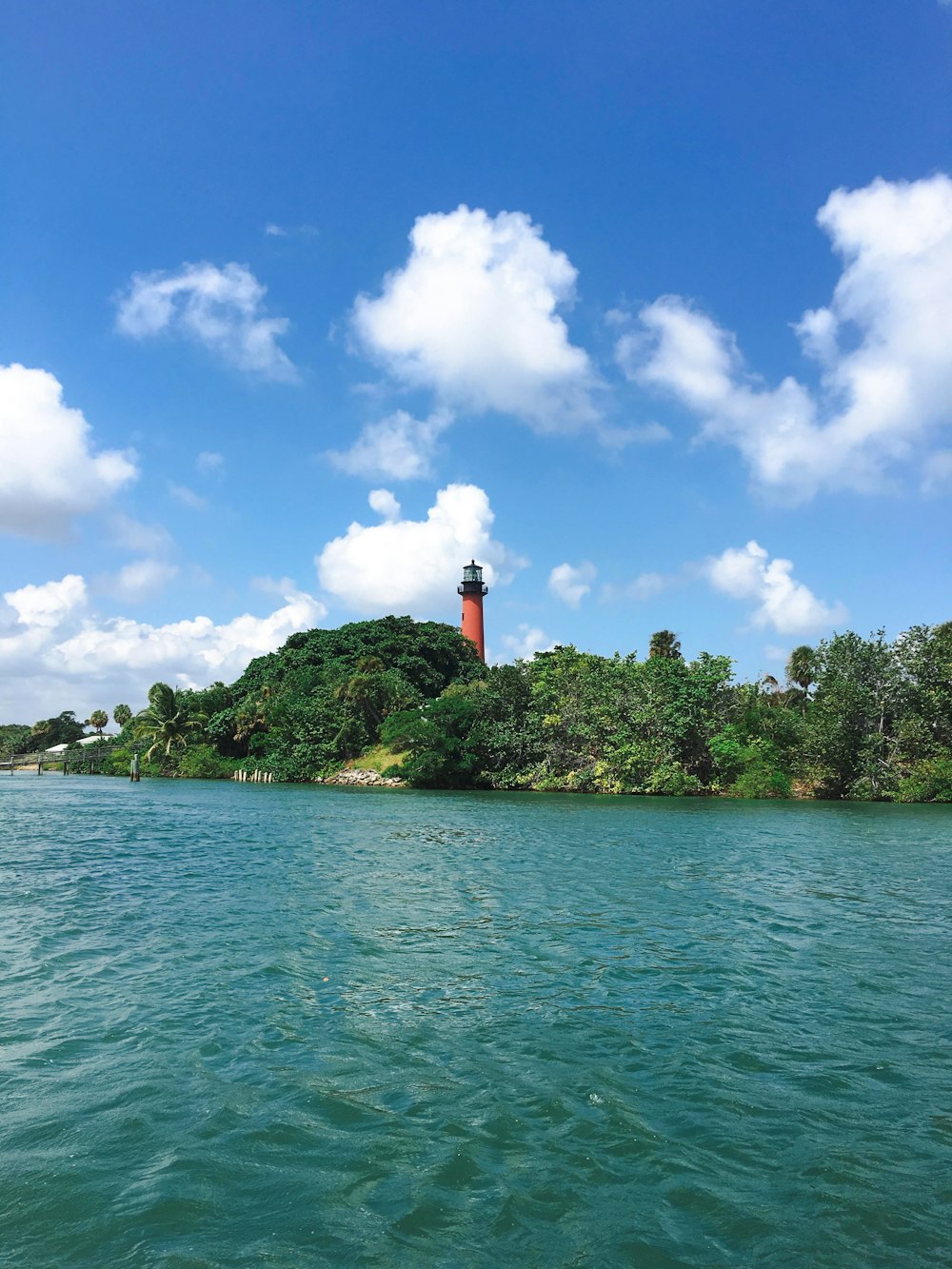 a light house on a small island in the middle of the ocean