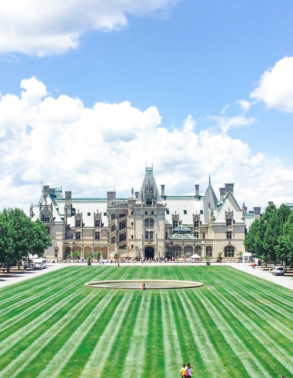 a large building with a lawn in front of it