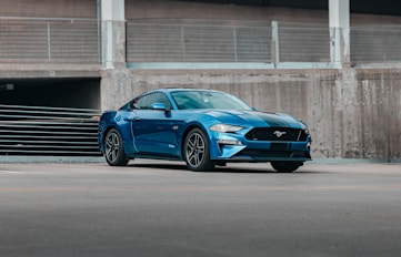 a blue car parked in front of a building