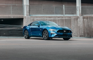 a blue car parked in front of a building