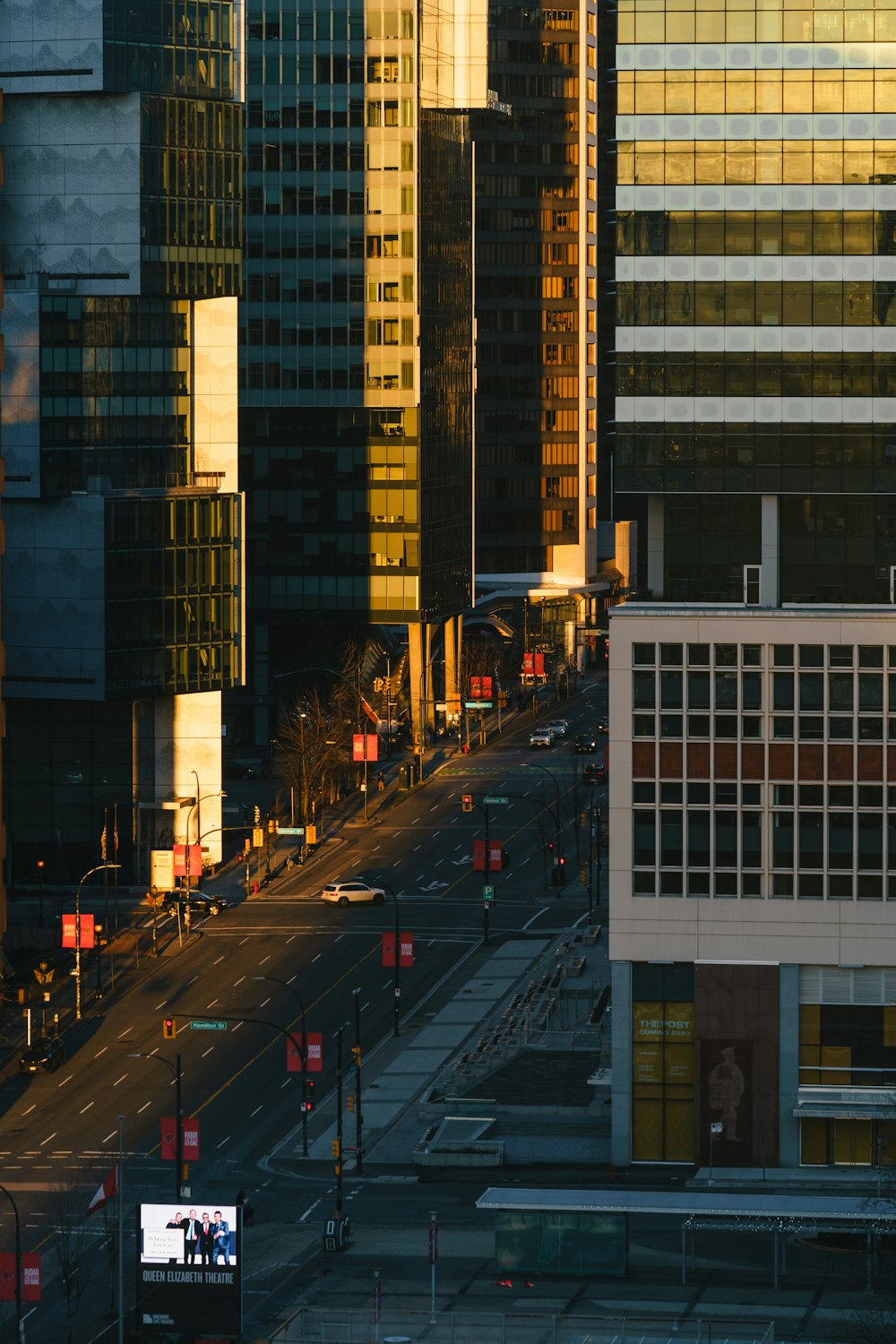 a city street with traffic lights and tall buildings