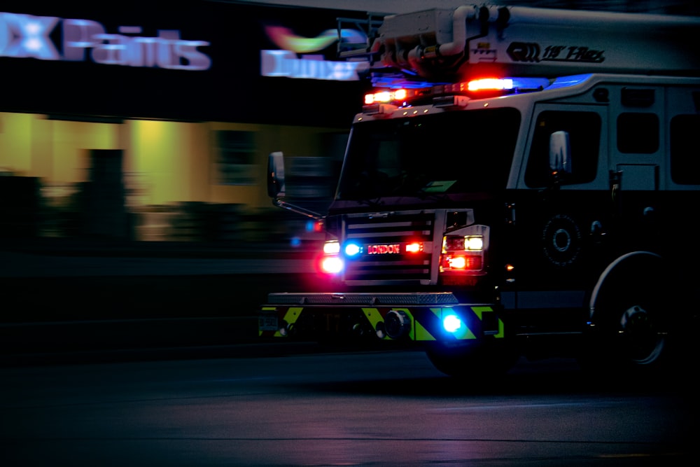 a fire truck with its lights on driving down the street