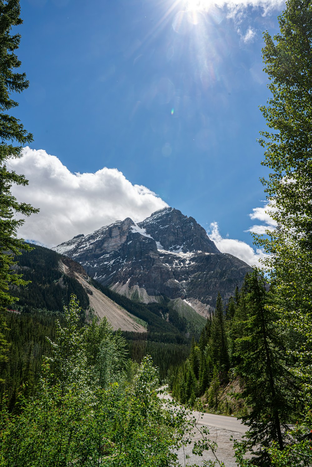 the sun shines brightly on a mountain range