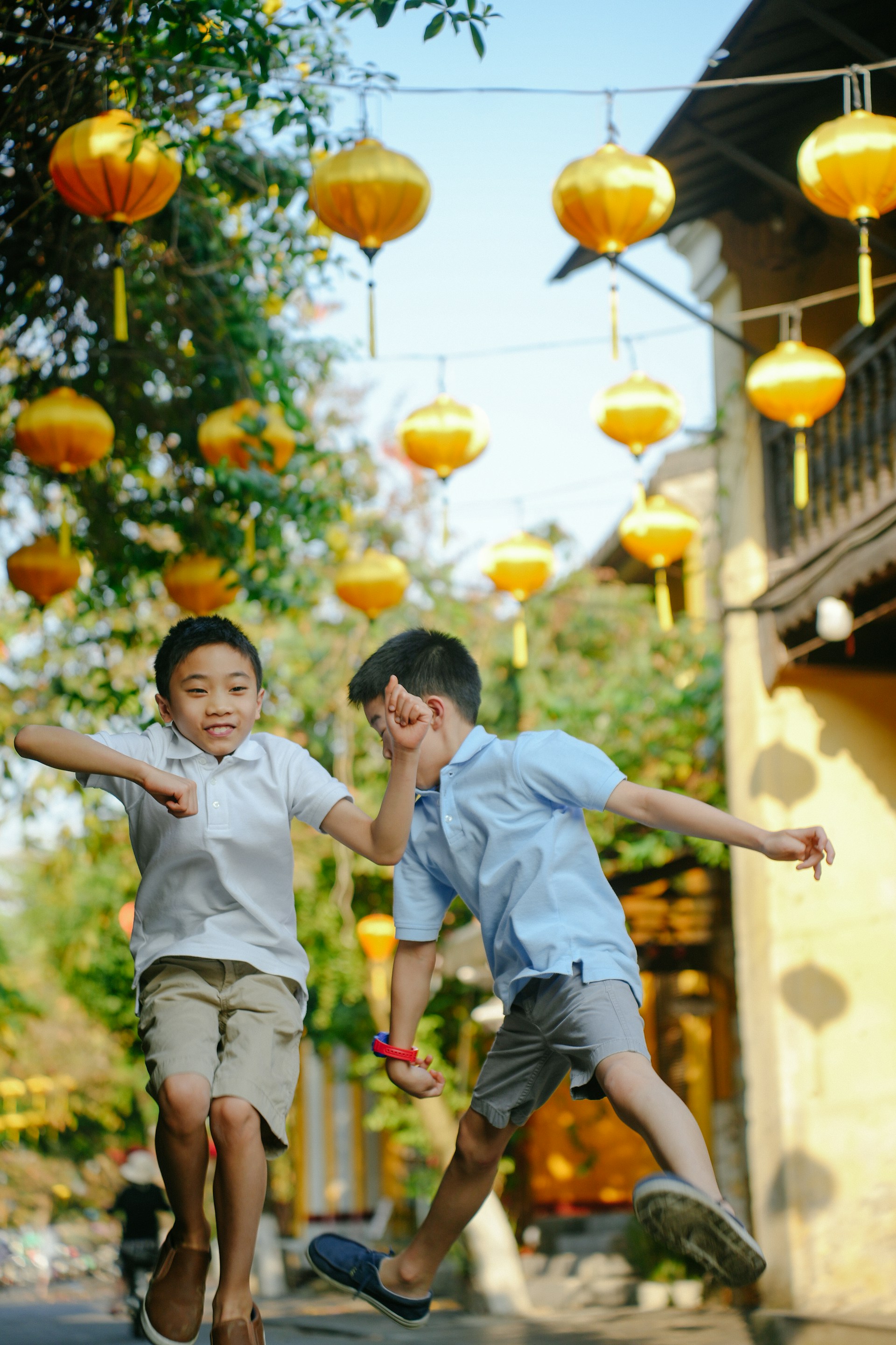 two young boys are jumping in the air