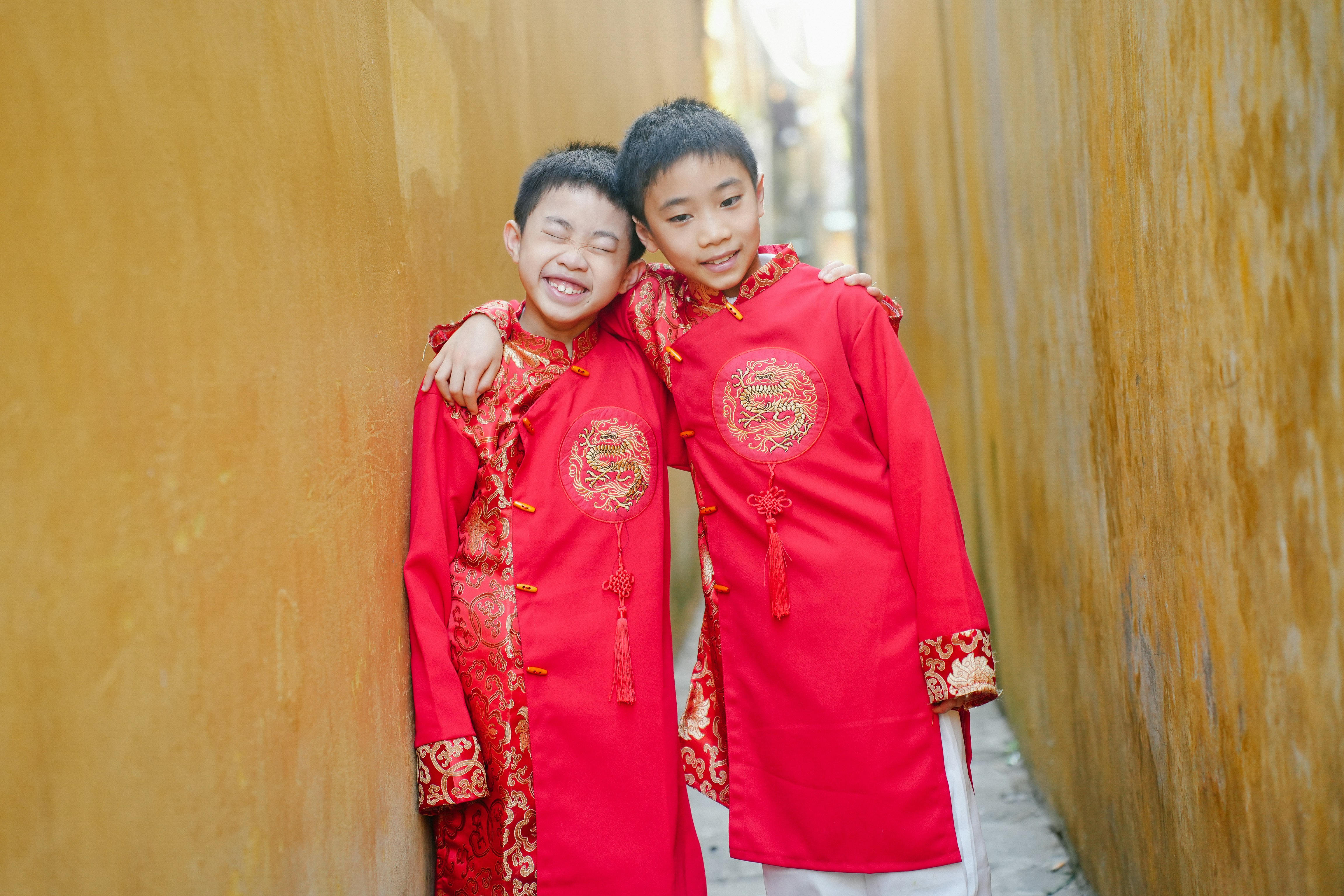 a couple of kids standing next to each other