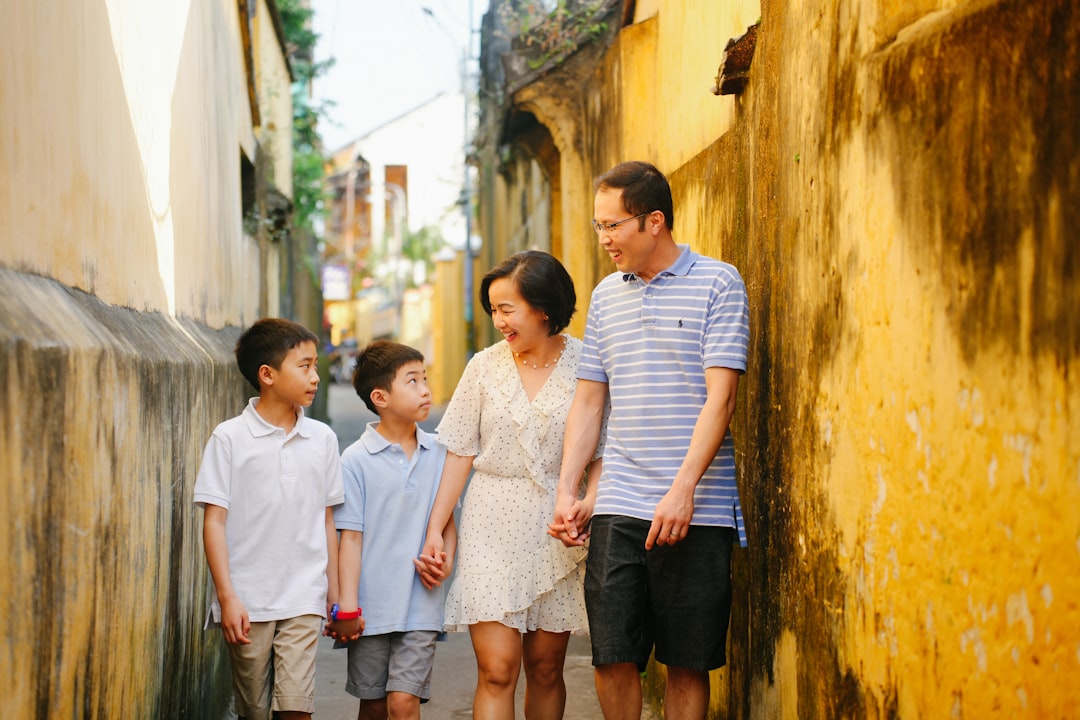 a group of people standing next to each other on a street,