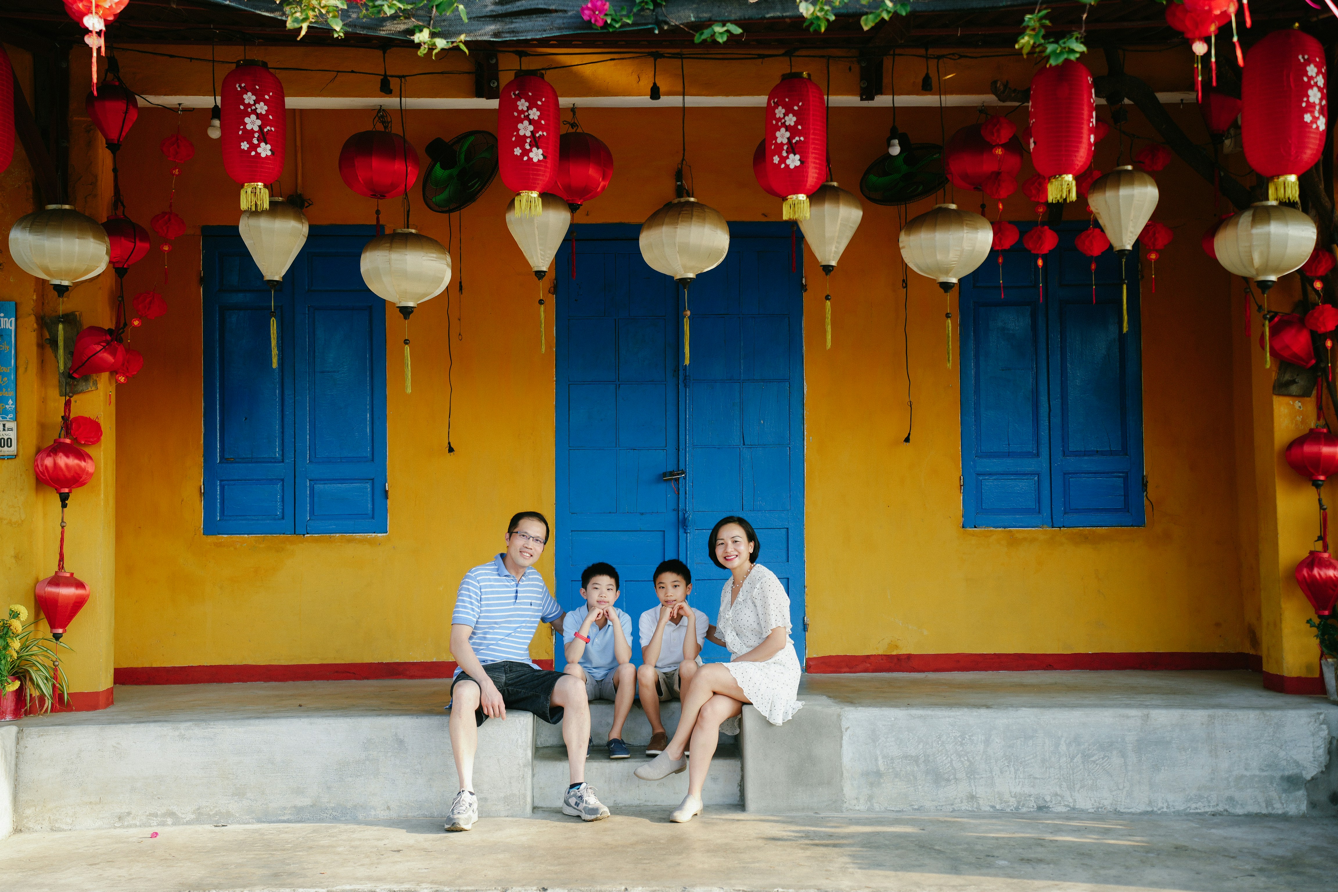 Family standing beside an electric car connected to a public charging station