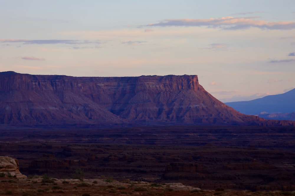 a view of a mountain with a sky in the background