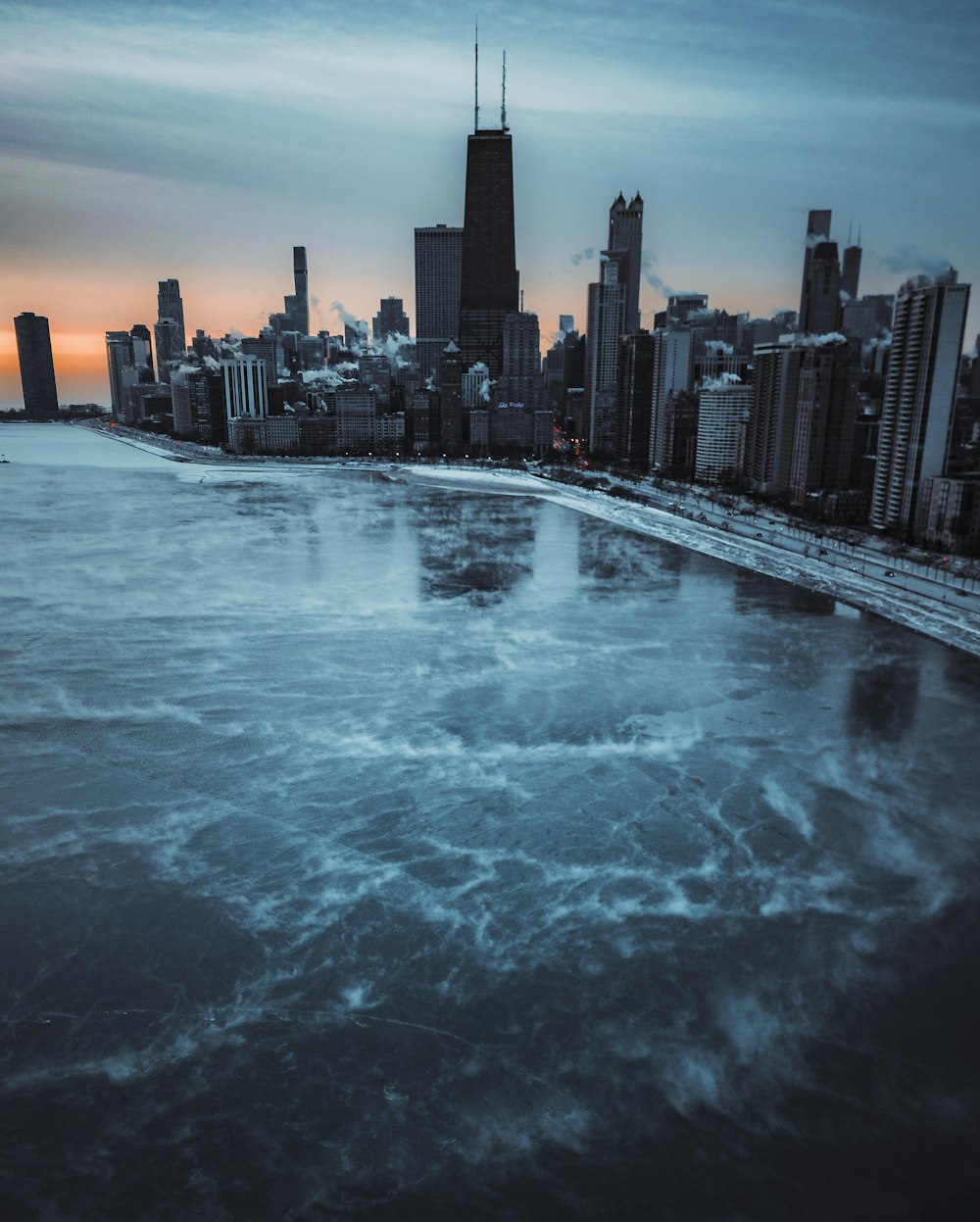 a large body of water with a city in the background