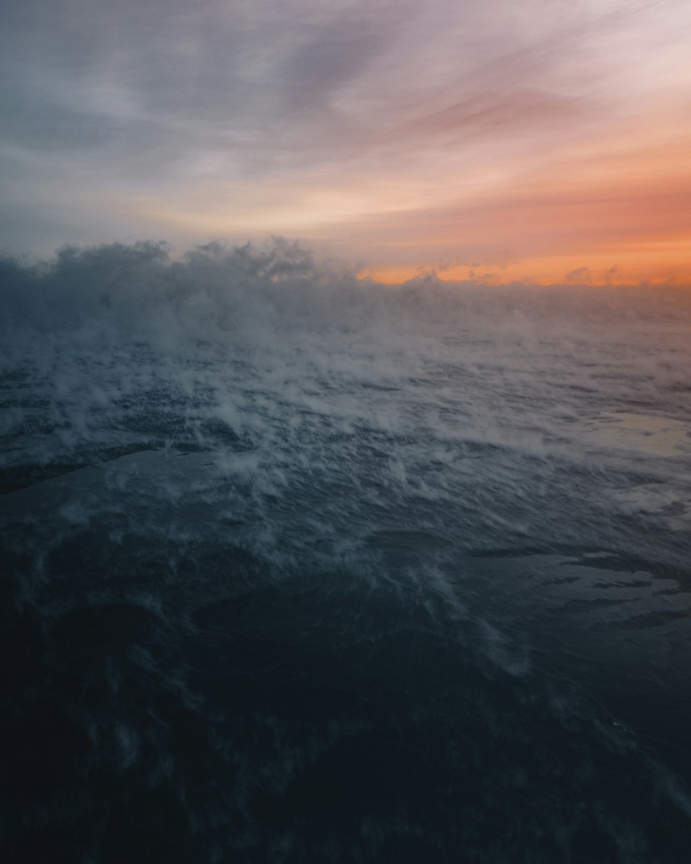 a large body of water under a cloudy sky