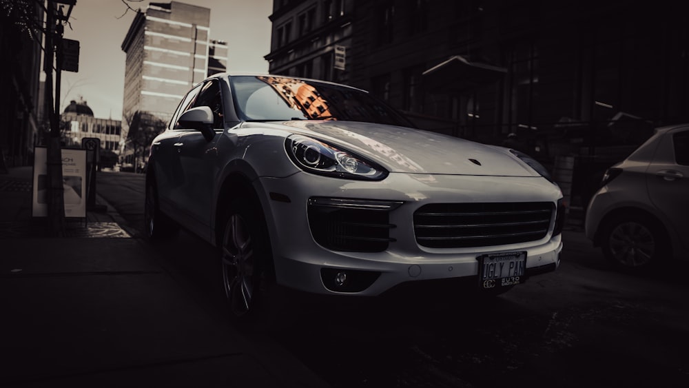 a white car parked on the side of a street