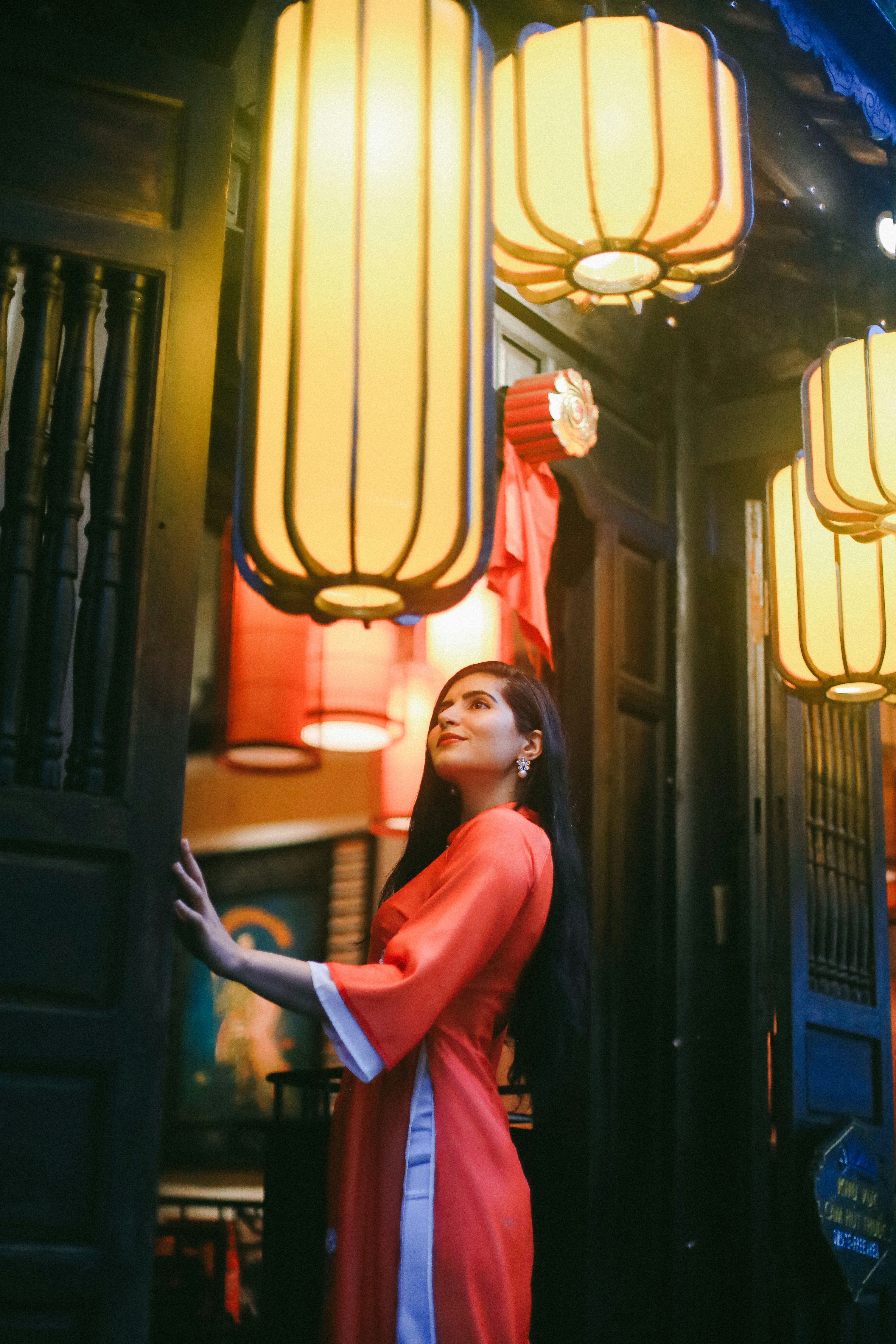 a woman in a red dress standing in front of a building