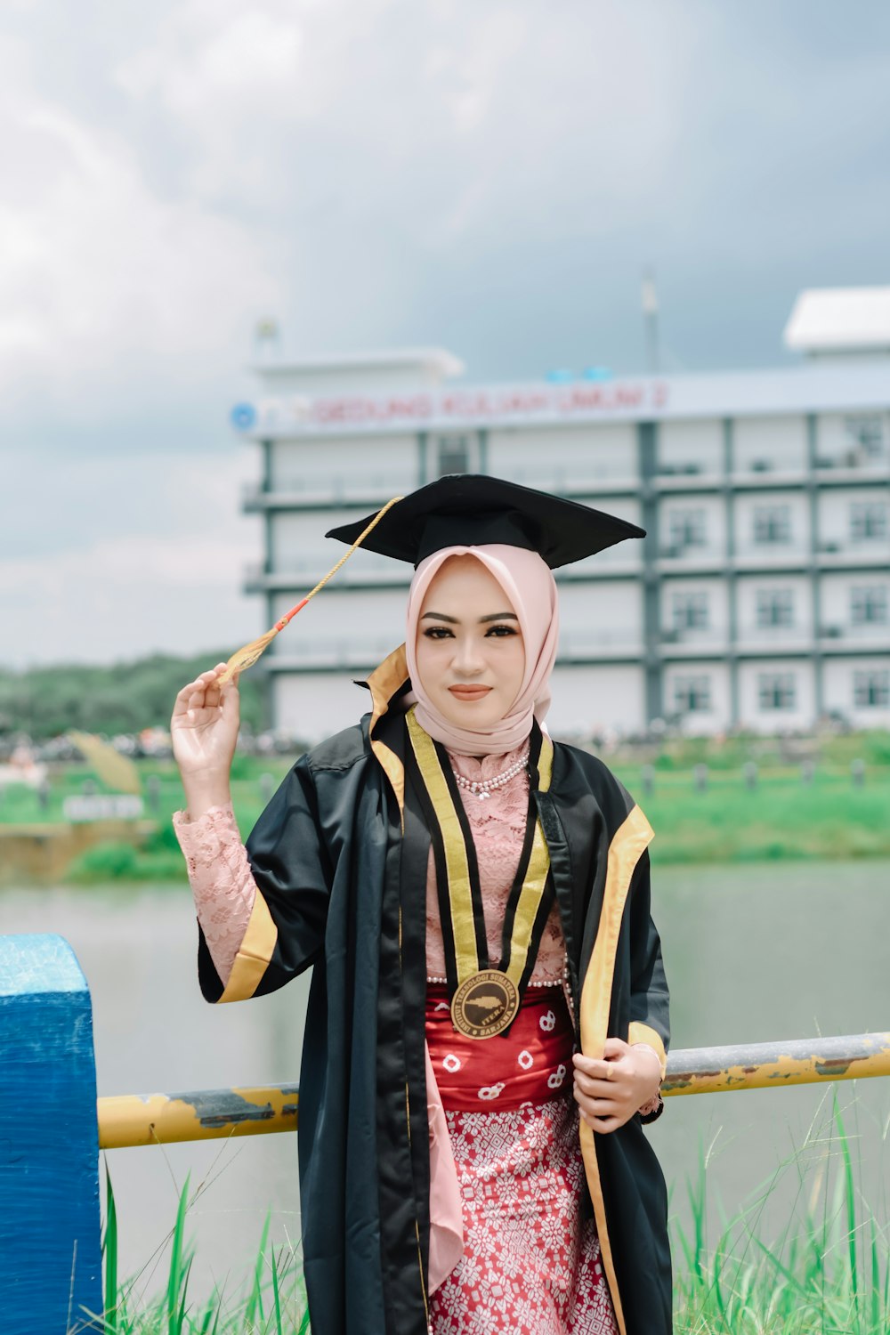 a woman in a graduation gown holding a diploma