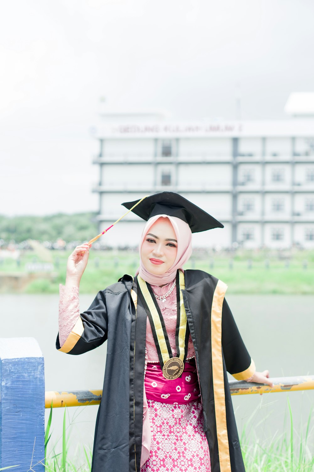 a woman in a graduation gown holding a diploma