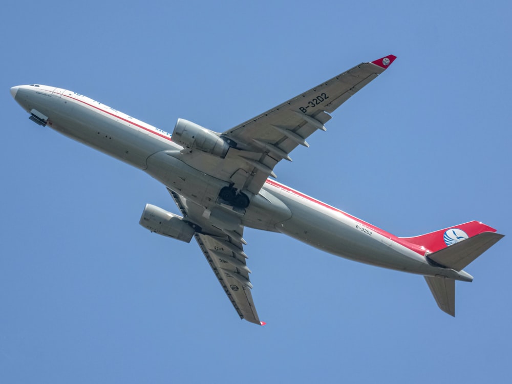 a large passenger jet flying through a blue sky