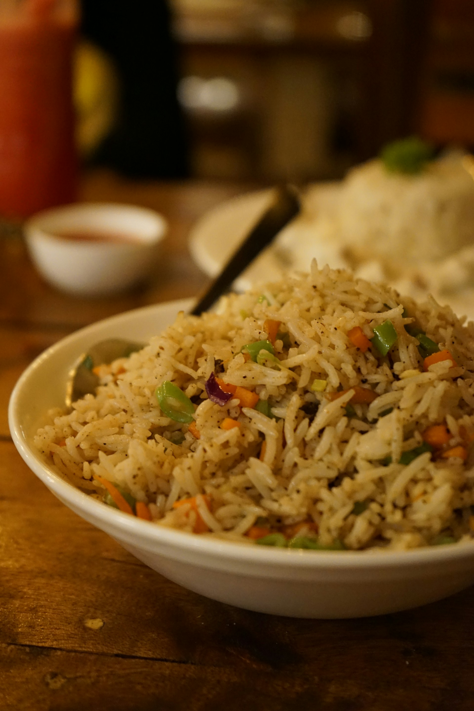 a white bowl filled with rice and vegetables