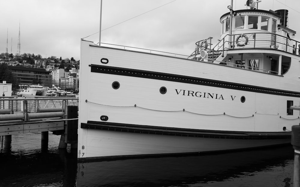 a large white boat docked at a pier