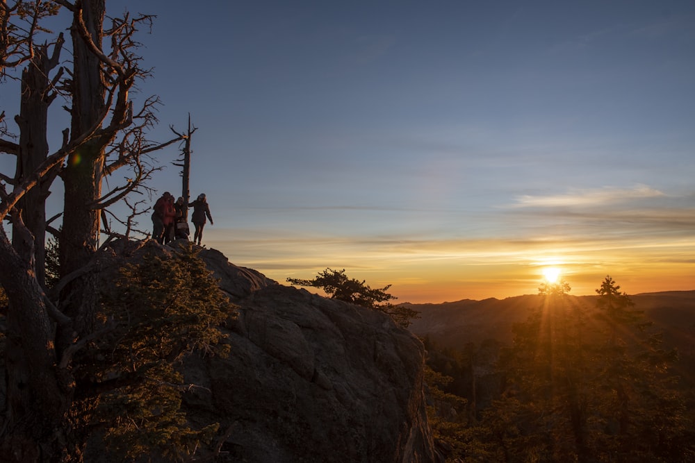 a couple of people standing on top of a mountain