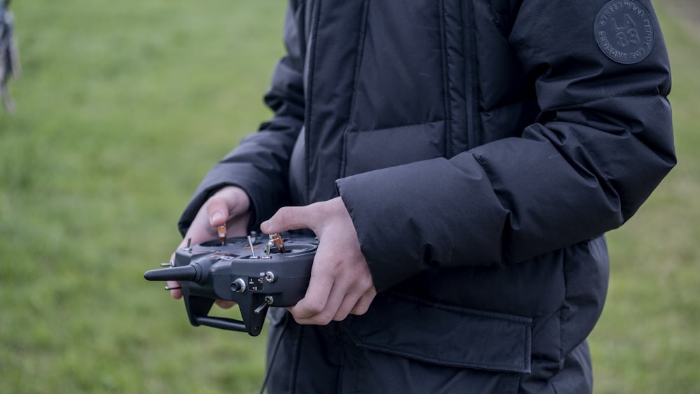 a person holding a remote control device in their hands