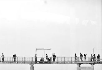 a group of people standing on a bridge