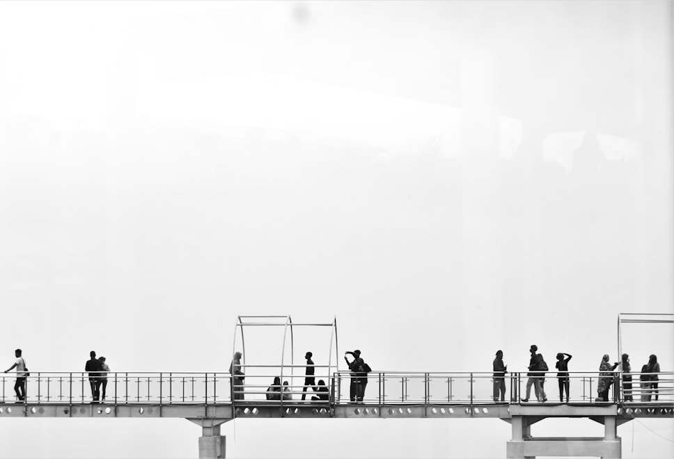 a group of people standing on a bridge