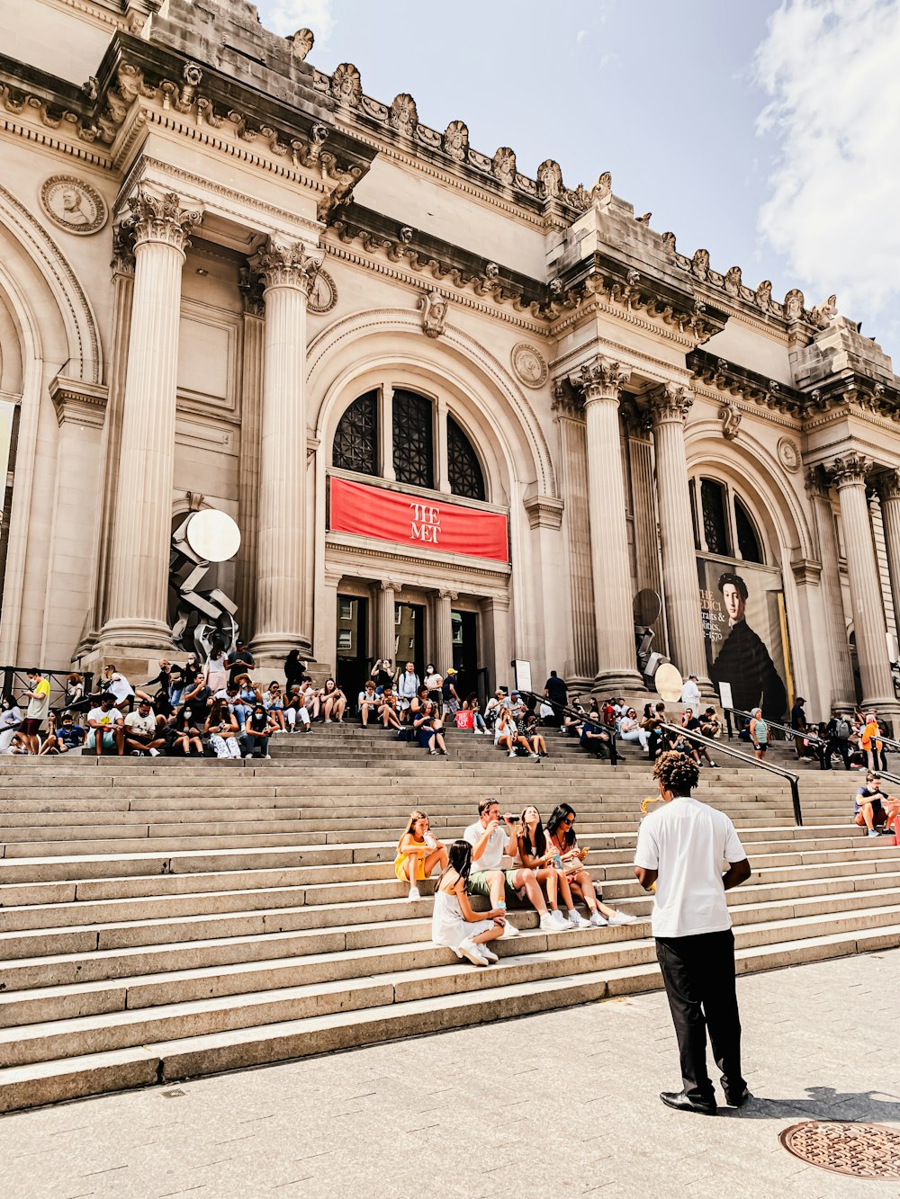 a group of people sitting on the steps of a building