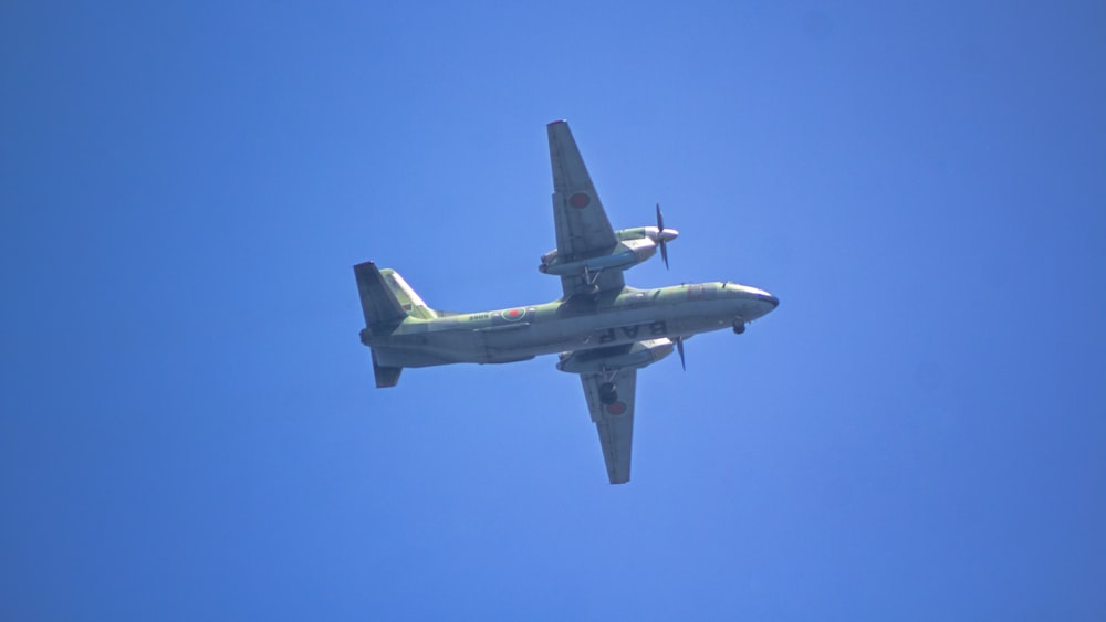 an airplane is flying in the blue sky