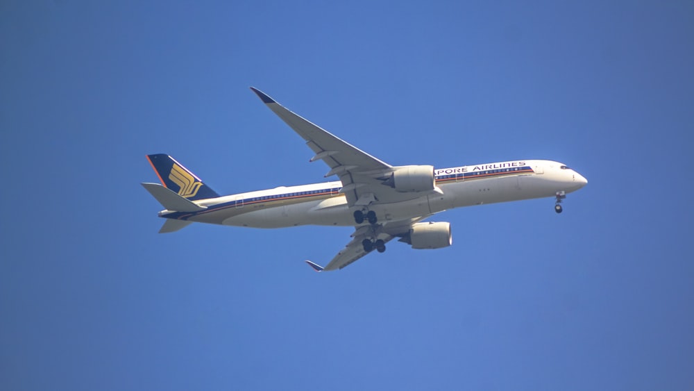 a large jetliner flying through a blue sky