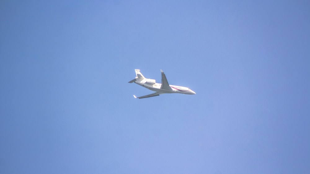 an airplane is flying in the clear blue sky