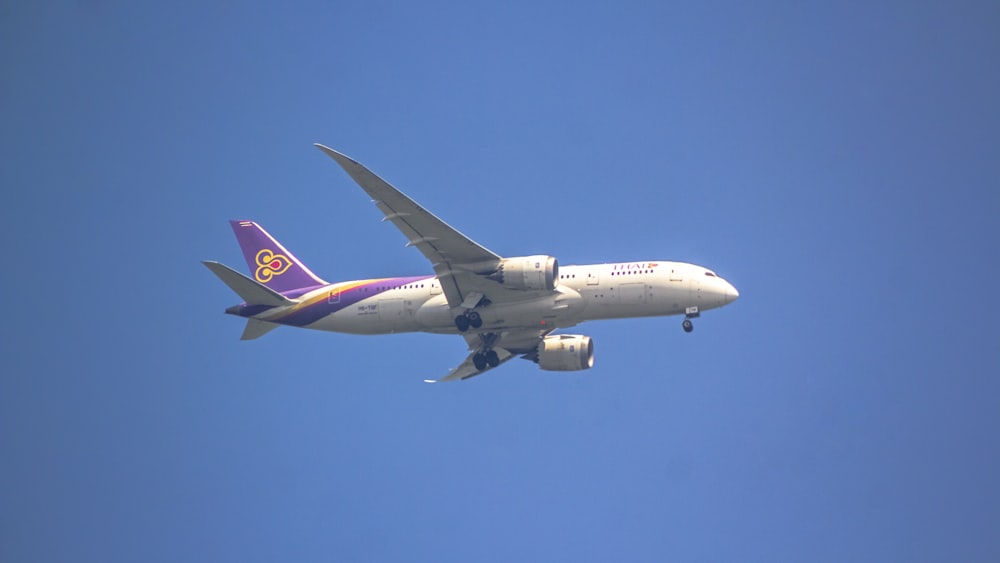 a large passenger jet flying through a blue sky