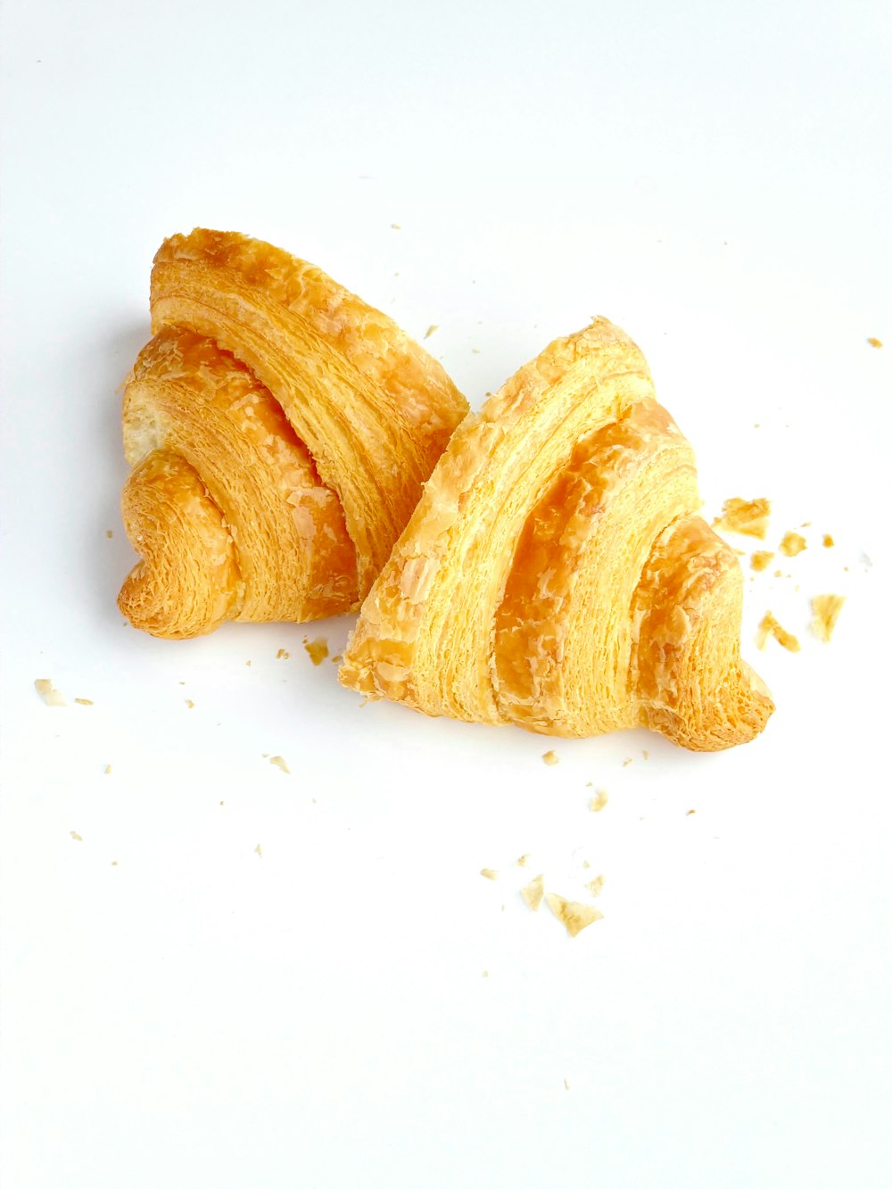 a couple of pieces of bread sitting on top of a white table